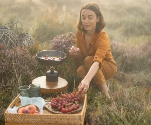 woman preparing breakfast in the grass