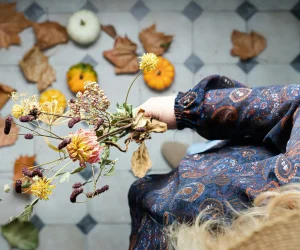 woman holding a dried autumn flower