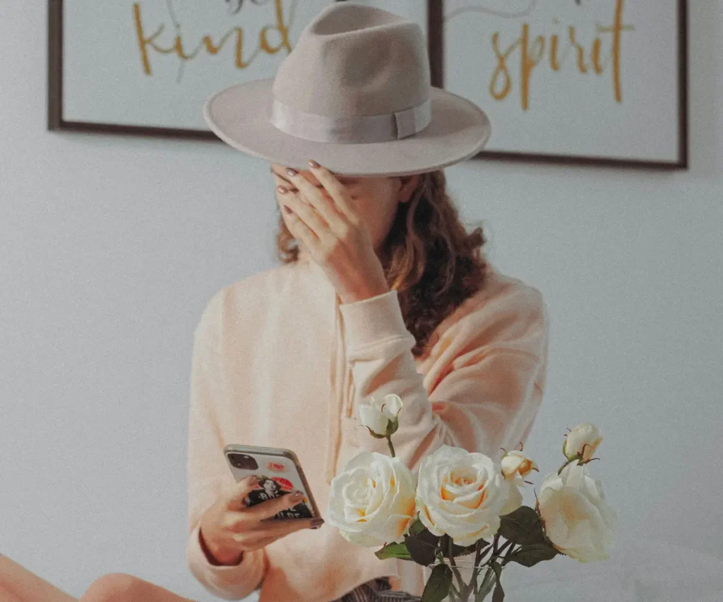 woman in hat with phone