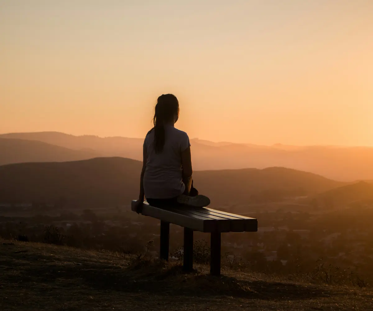 woman looking to sunset
