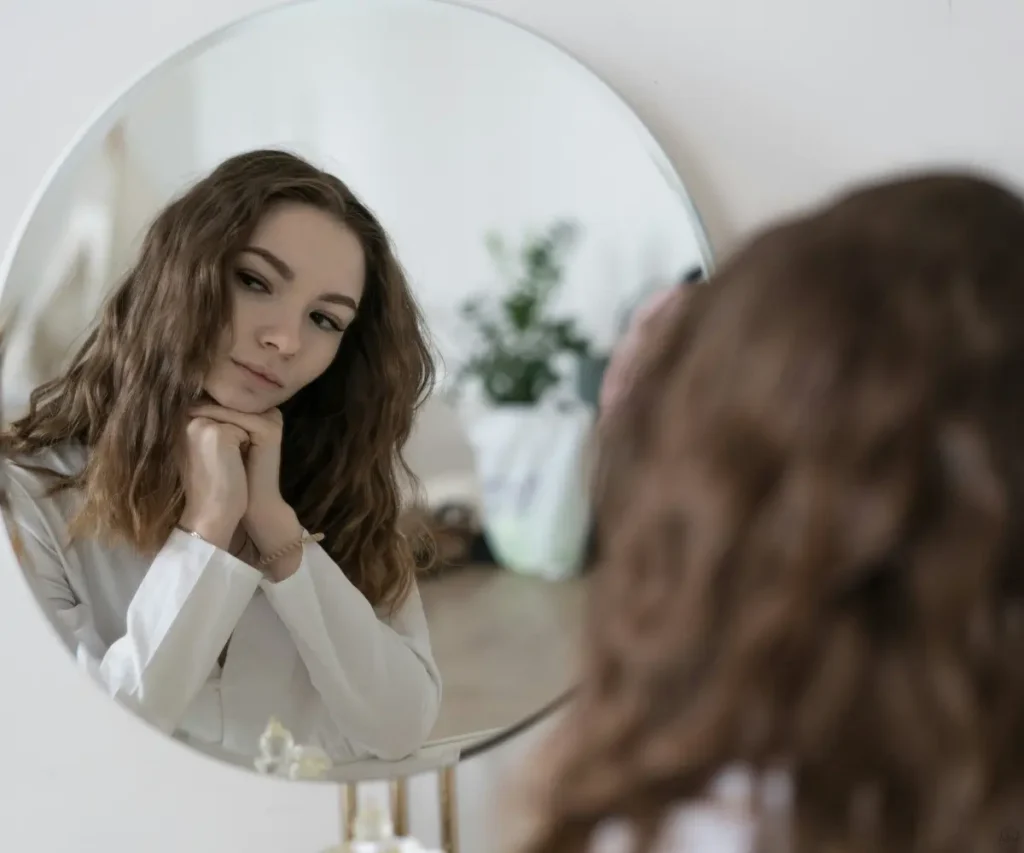 woman looking to mirror